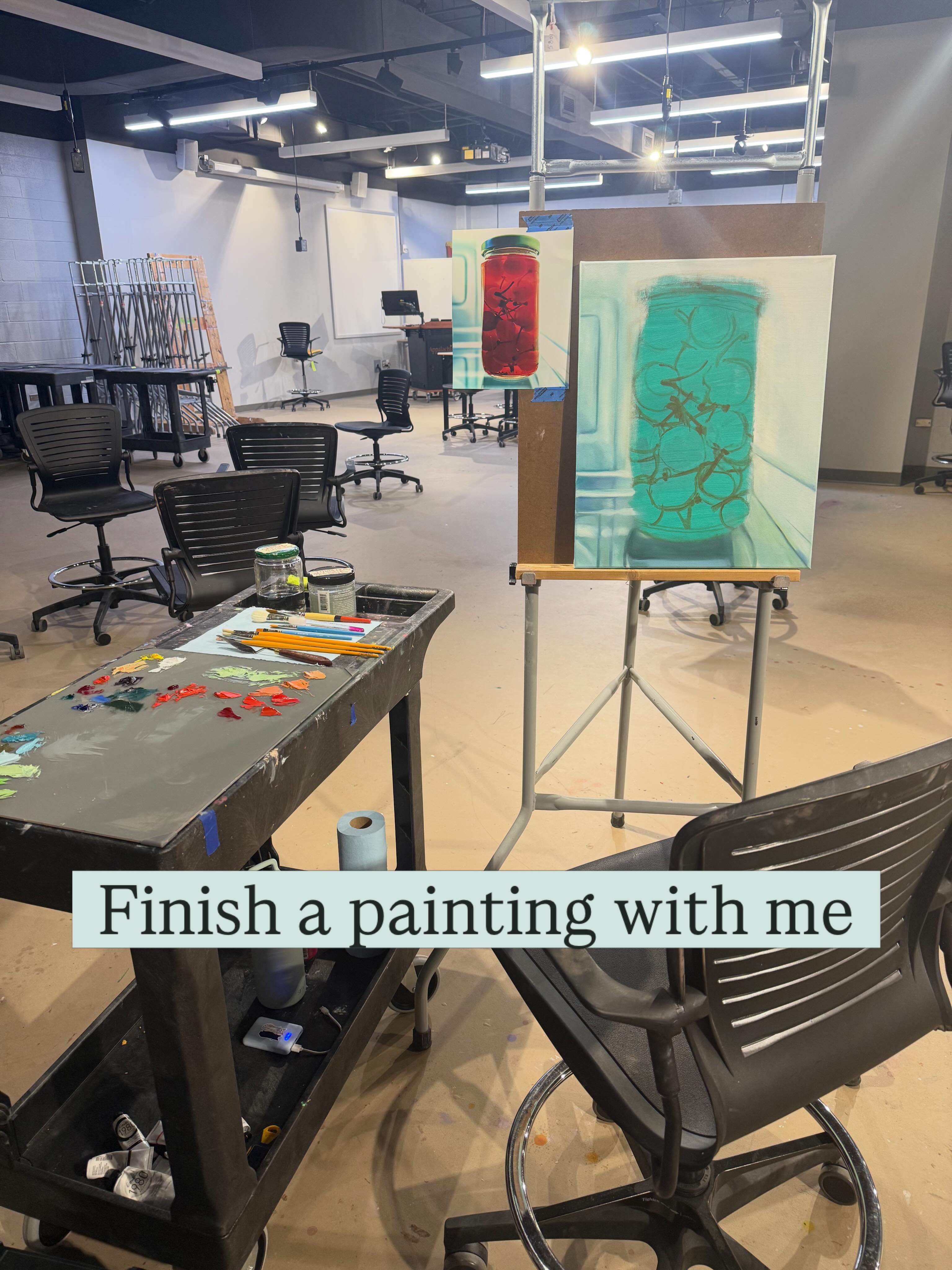 Studio table and easel with a painting in progress